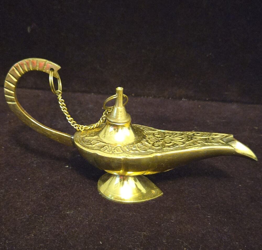 Engraved brass Aladdin-style genie lamp.